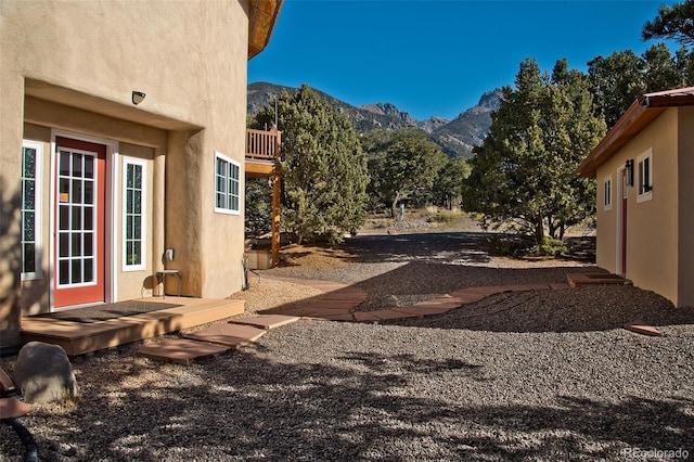 view of yard featuring a mountain view and a balcony