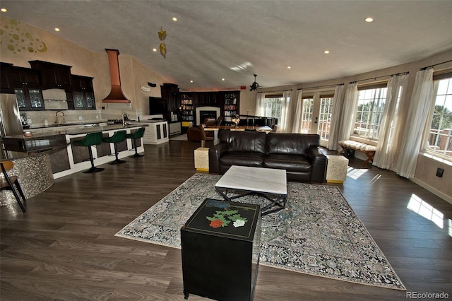 living room featuring french doors, lofted ceiling, dark hardwood / wood-style floors, and sink