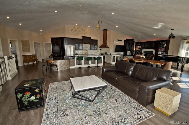 living room with high vaulted ceiling, ceiling fan, and dark hardwood / wood-style floors