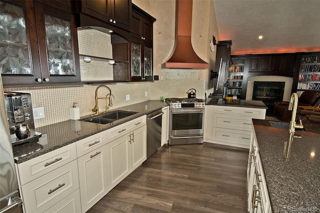 kitchen with ventilation hood, appliances with stainless steel finishes, dark hardwood / wood-style flooring, sink, and white cabinets