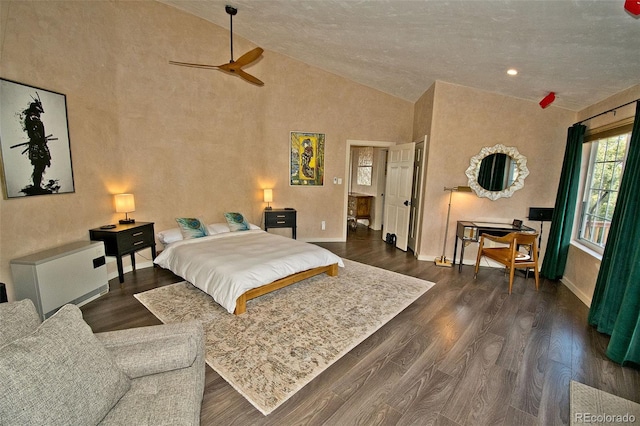 bedroom featuring ceiling fan, dark hardwood / wood-style floors, and high vaulted ceiling