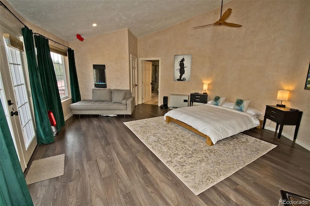 bedroom featuring dark wood-type flooring, vaulted ceiling, and ceiling fan