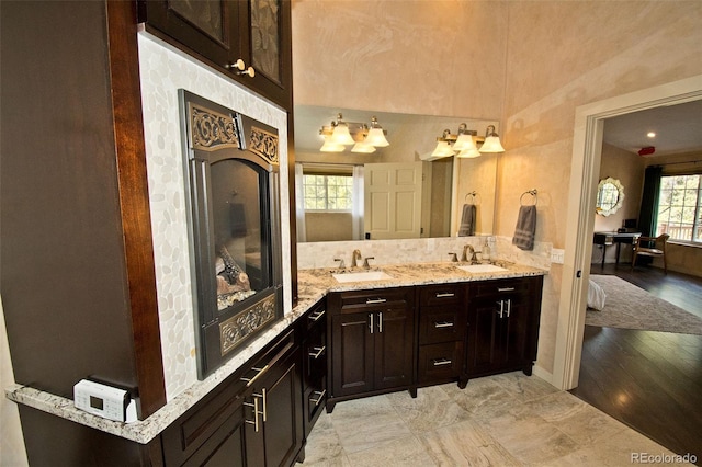 bathroom with hardwood / wood-style flooring, vanity, and vaulted ceiling