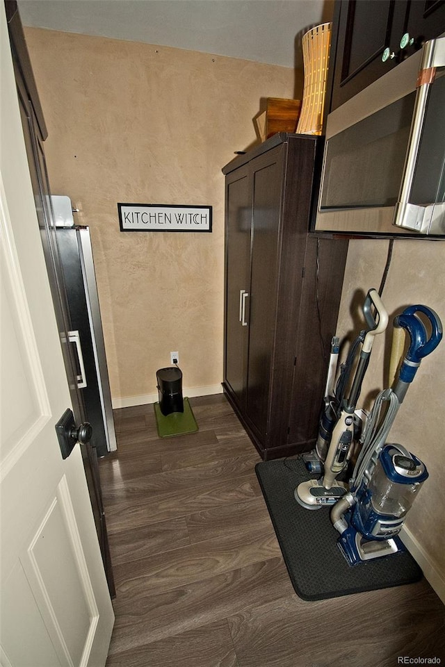 kitchen with dark brown cabinetry and dark hardwood / wood-style floors