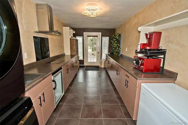 kitchen featuring wall chimney exhaust hood, dark tile patterned floors, white fridge, and black refrigerator