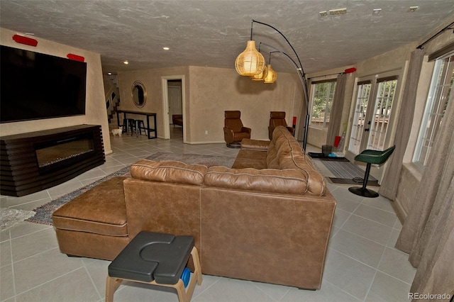 tiled living room with a textured ceiling