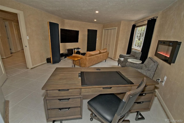 tiled office with a textured ceiling and built in desk