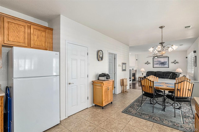 dining room featuring a notable chandelier and light tile patterned flooring