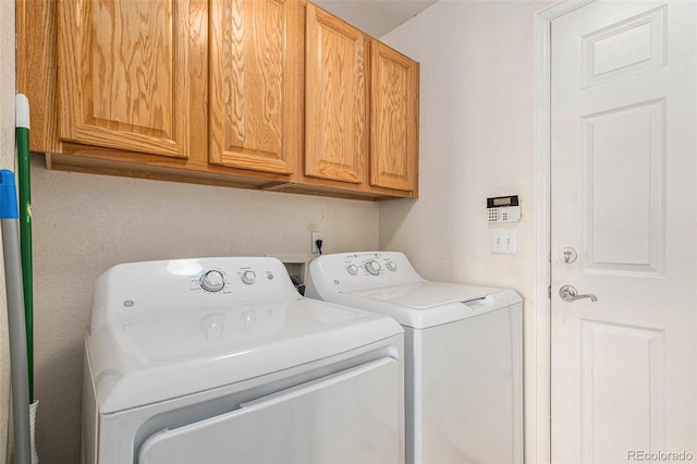 laundry area featuring cabinets and washing machine and dryer