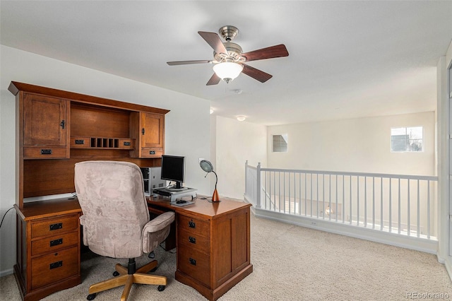 carpeted home office with ceiling fan