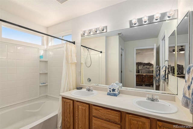 bathroom with vanity, shower / tub combo, and a textured ceiling