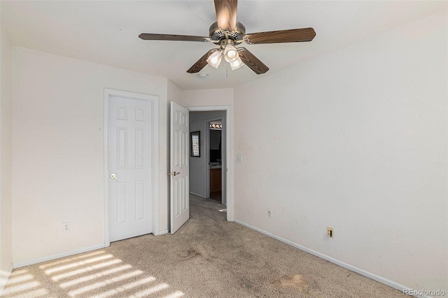 unfurnished bedroom with light colored carpet and ceiling fan