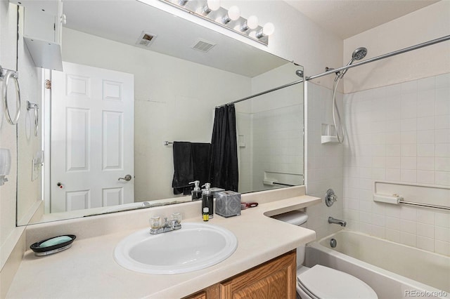 full bathroom featuring vanity, shower / bath combination with curtain, and toilet