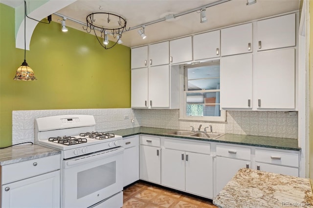 1832 S Saint Paul St, Denver, CO 80210 - kitchen with white gas stove, rail lighting, white cabinetry, and decorative backsplash