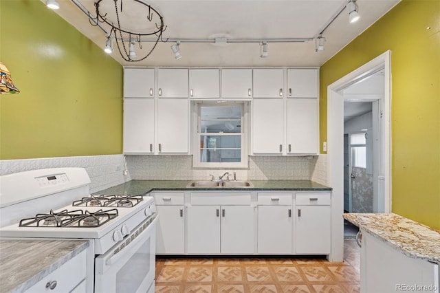 1832 S Saint Paul St, Denver, CO 80210 - kitchen with white gas range oven, white cabinetry, tasteful backsplash, and rail lighting