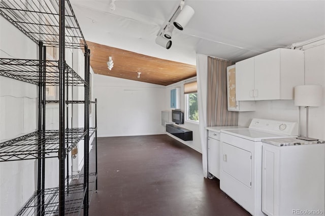 1832 S Saint Paul St, Denver, CO 80210 - kitchen featuring lofted ceiling, light countertops, finished concrete floors, white cabinetry, and washing machine and clothes dryer