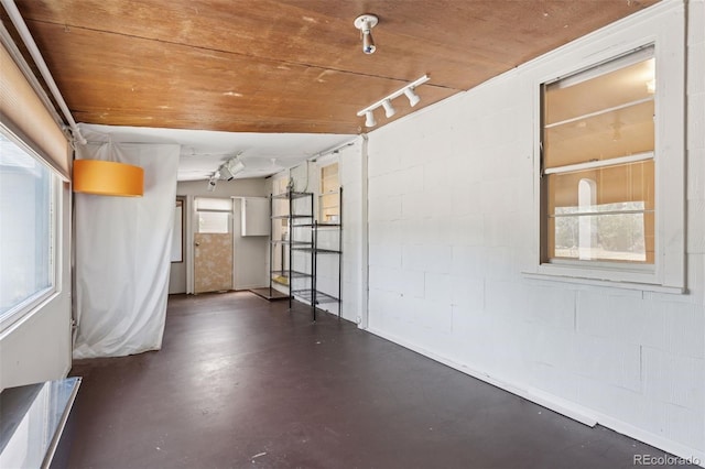 1832 S Saint Paul St, Denver, CO 80210 - spare room featuring concrete floors, concrete block wall, and rail lighting