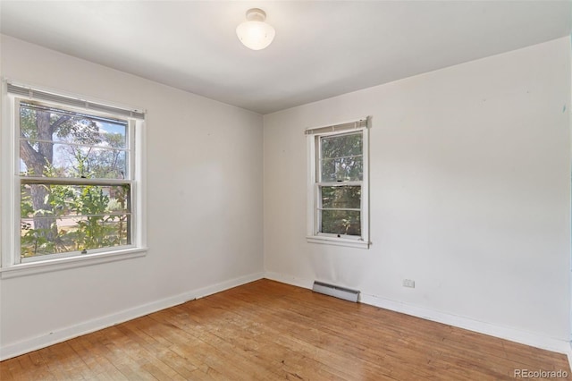 1832 S Saint Paul St, Denver, CO 80210 - spare room with a baseboard heating unit and light wood-type flooring