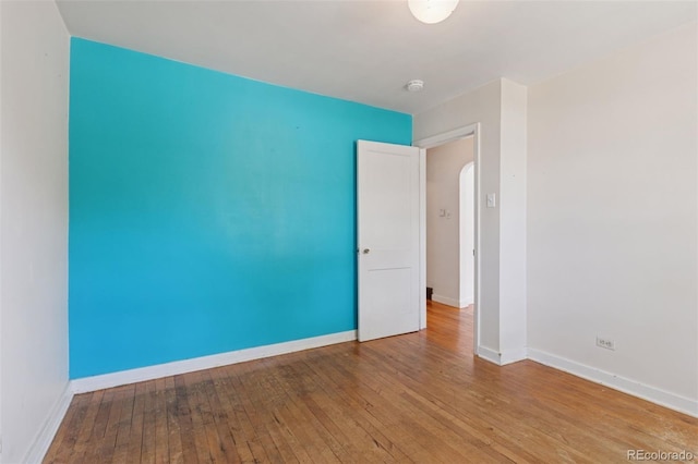 1832 S Saint Paul St, Denver, CO 80210 - spare room featuring hardwood / wood-style floors and arched walkways