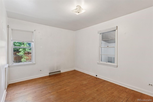1832 S Saint Paul St, Denver, CO 80210 - unfurnished room featuring hardwood / wood-style floors and a baseboard radiator