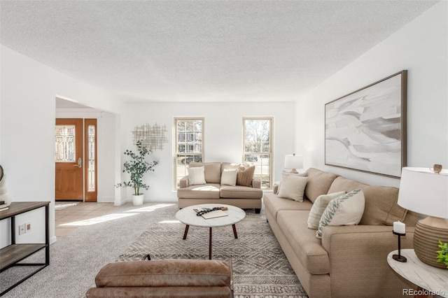 living area featuring light carpet and a textured ceiling