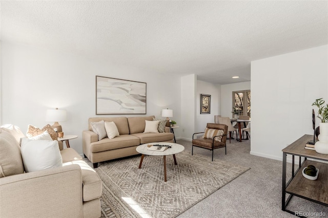 living area featuring a textured ceiling, baseboards, and light colored carpet