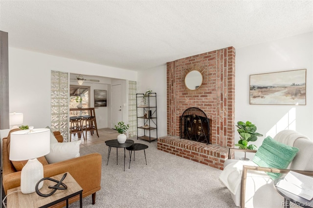 carpeted living room with a textured ceiling and a fireplace