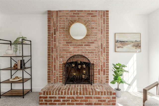 interior details featuring a textured ceiling, carpet floors, and a fireplace