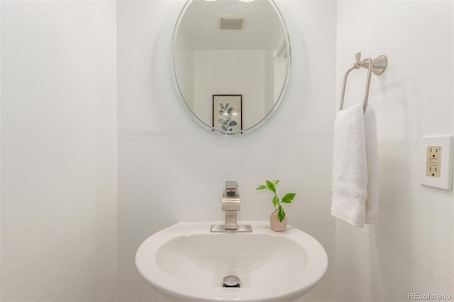 bathroom featuring visible vents and a sink