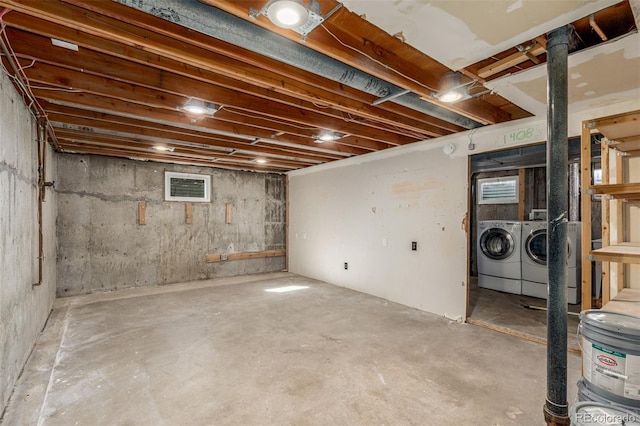 unfinished basement featuring washing machine and clothes dryer