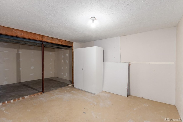 unfinished basement featuring a textured ceiling