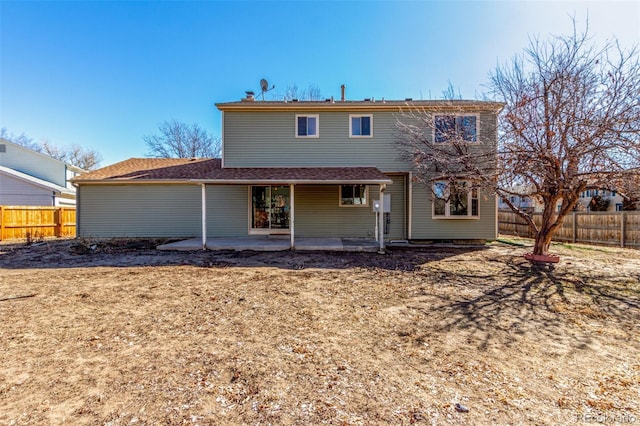 rear view of house featuring a patio area and a fenced backyard