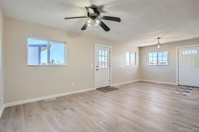 490 Washington Ave Unit A & B, Bennett, CO 80102 - entrance foyer featuring a textured ceiling, light wood-type flooring, and ceiling fan
