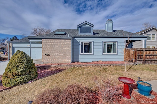 view of front of home with a garage and a front lawn