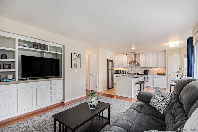 3289 Cummings Dr, Erie, CO 80516 - living room featuring light wood-style floors and baseboards