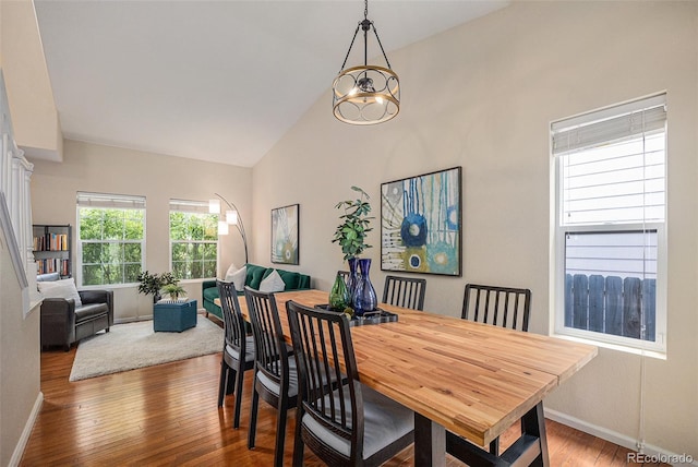 3289 Cummings Dr, Erie, CO 80516 - dining area featuring hardwood / wood-style floors and high vaulted ceiling
