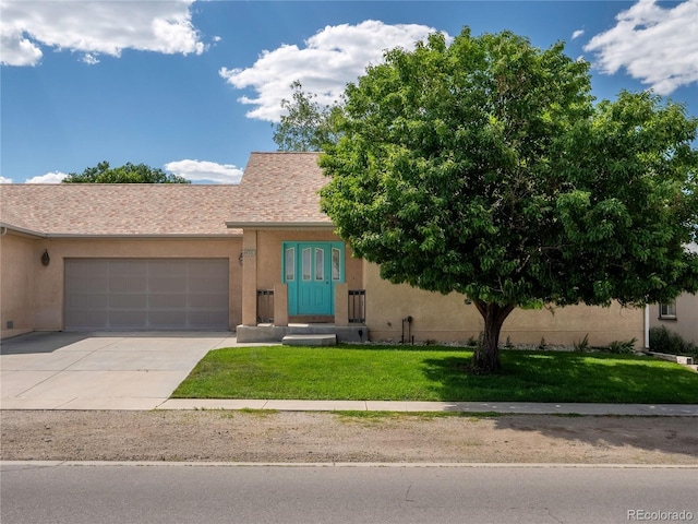 1436 H St Unit D, Salida, CO 81201 - view of front facade with an attached garage, stucco siding, concrete driveway, and a front yard