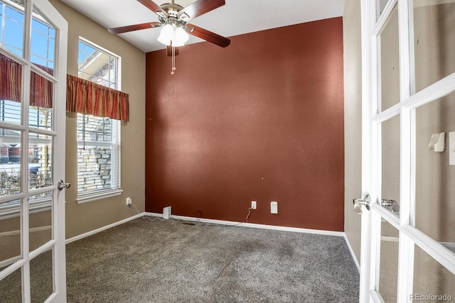 spare room featuring ceiling fan, french doors, and carpet floors