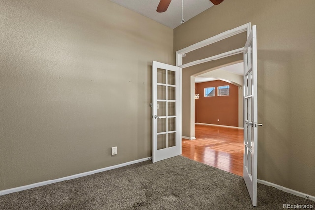 unfurnished room with ceiling fan, carpet floors, and french doors