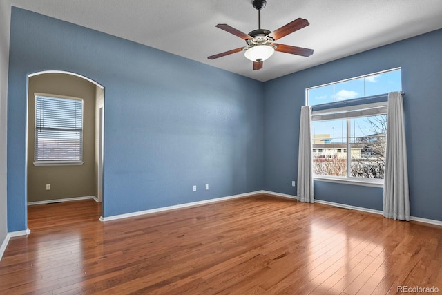 spare room with ceiling fan and wood-type flooring