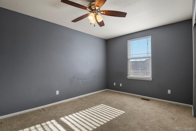 spare room featuring carpet flooring and ceiling fan