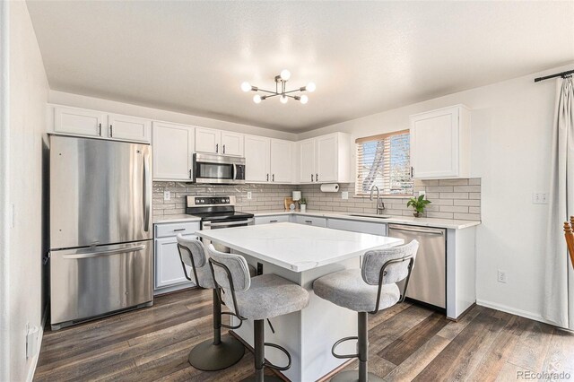 23813 Broadmoor Dr, Parker, CO 80138 - kitchen with a sink, dark wood-type flooring, a chandelier, and stainless steel appliances