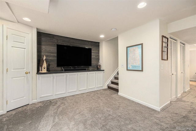 23813 Broadmoor Dr, Parker, CO 80138 - unfurnished living room with an accent wall, light colored carpet, recessed lighting, and stairs