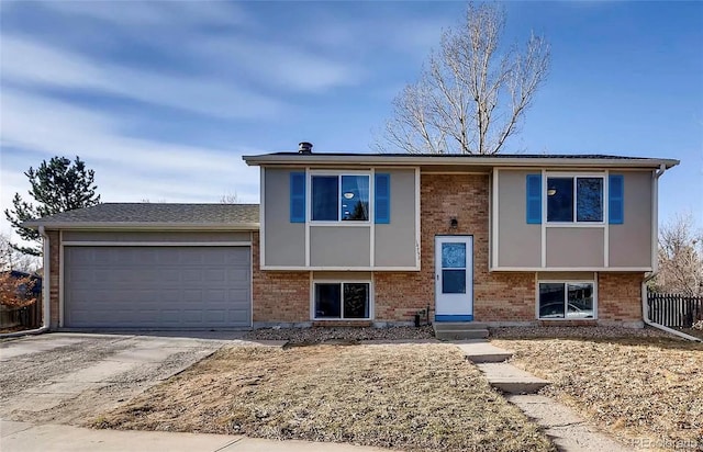 14798 E Temple Dr, Aurora, CO 80015 - bi-level home with brick siding, a garage, entry steps, and concrete driveway