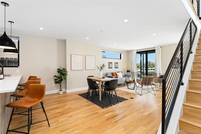 dining room with recessed lighting, stairs, light wood finished floors, and baseboards