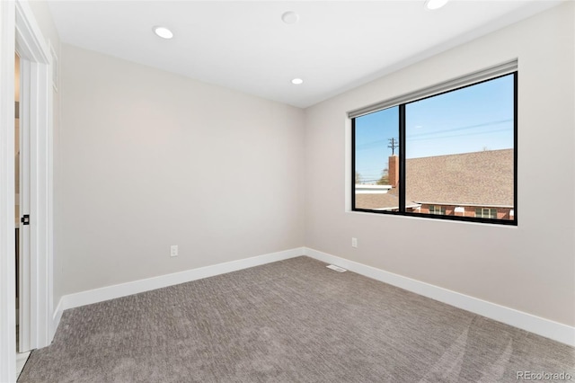 spare room with carpet floors, baseboards, and recessed lighting
