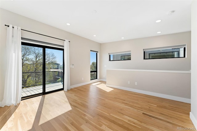 spare room with recessed lighting, baseboards, and light wood-type flooring