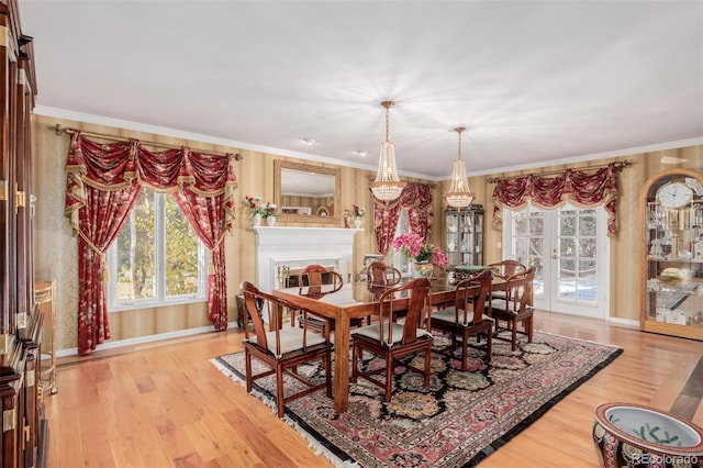 dining area featuring french doors, light hardwood / wood-style floors, and ornamental molding