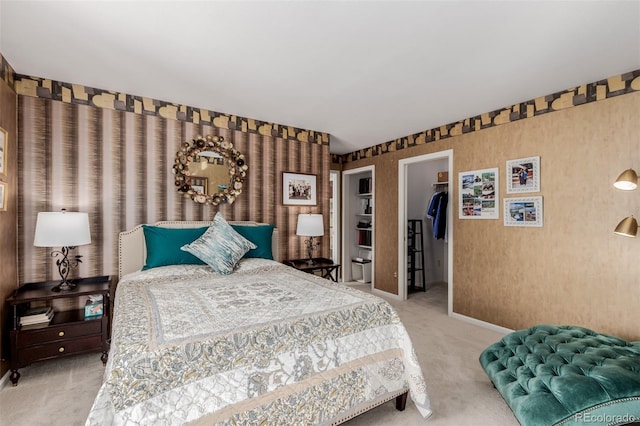 carpeted bedroom featuring a spacious closet and a closet