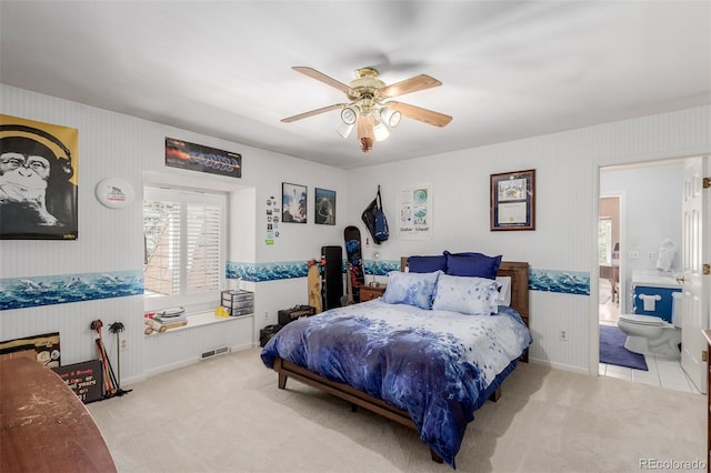 carpeted bedroom featuring connected bathroom and ceiling fan